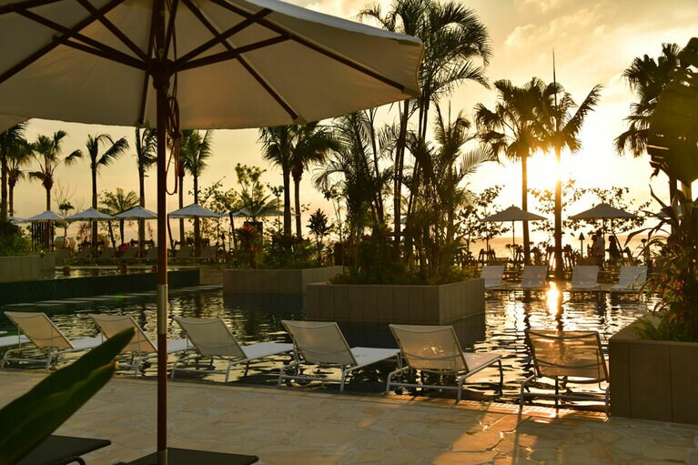 幻想的な色彩に染まるサンセットタイムのプールサイド。