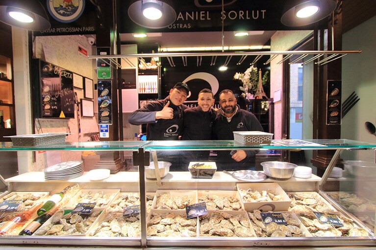 笑顔で生ガキを開けてくれるナイスガイたち。