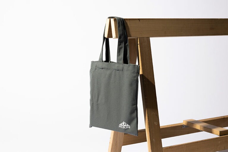 焚き火サイドタフテーブル ミニ　テーブルがすっぽり入るトートバッグ付き。使用時：W305×D225×H90mm。収納時：W160×D200×H30mm。3,630円。