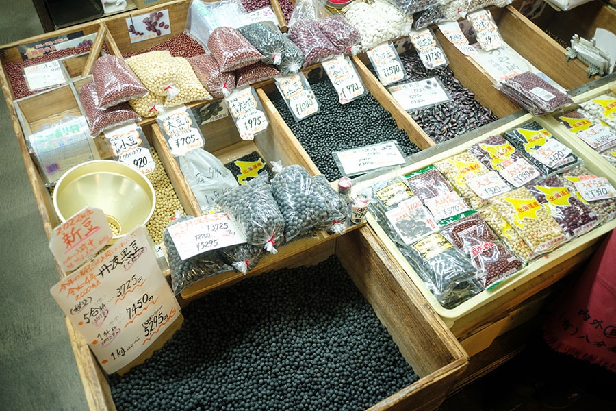 大豆や黒豆、金時豆などたくさんの豆類が、木箱に入って売られています。