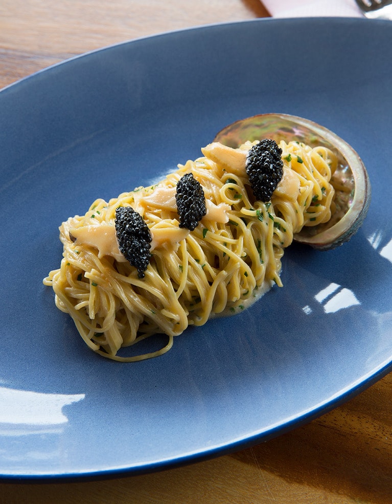 あわびのスパゲティは、オシェトラキャビアと、ゆずバター、チャイブとともに。あわびの貝殻からあふれ出ているような盛り付けが楽しい。(C)フォーシーズンズリゾート
