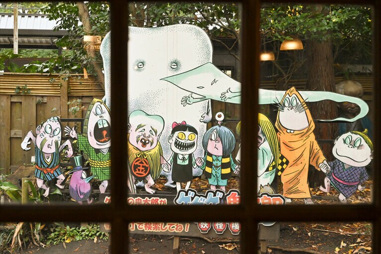 1Fの喫茶スペースには、ぬいぐるみやイラストが飾ってある。よく見てみると、背もたれはぬり壁だ！©水木プロ