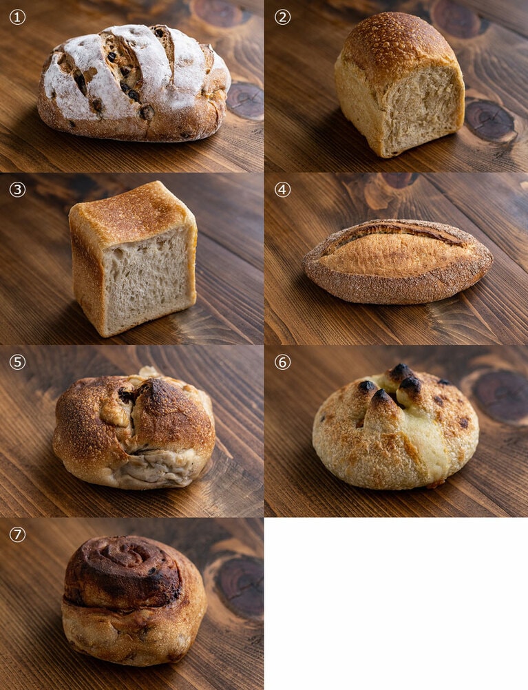 【宗像堂「3,000円パンセット」おまかせ便の一例】① くるみ＆カレンズ（中）、② 黒糖山食パン、③ プ レーン角食、④ 読谷カントリーブレッド、⑤ バナナ・こくるれ、⑥ アーサチーズ、⑦ 黒糖シナモンロール。