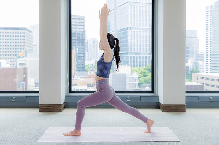 息を吸って腕を前から上げて耳の横に伸ばし、息を吐いて前ひざを曲げて踏み込む。