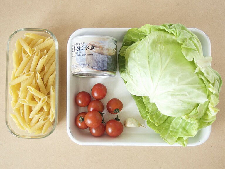 材料(4人前)。鯖の水煮缶：1缶／キャベツ：3枚／ミニトマト：8個／にんにく：1個／ショートパスタ：200g／オリーブオイル：小さじ2／塩：少々。